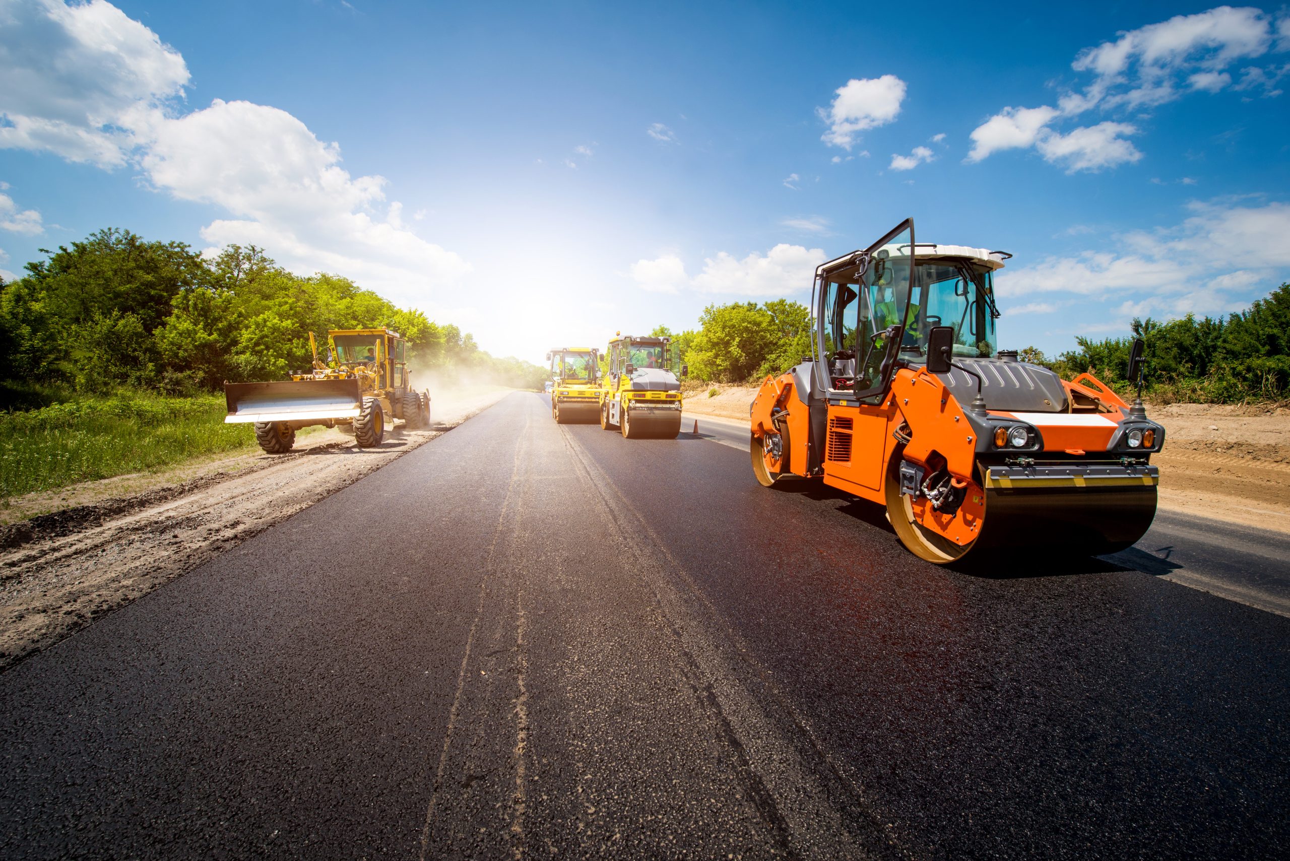 industrial landscape with rollers that rolls a new asphalt in th Asphalt Paving Services
